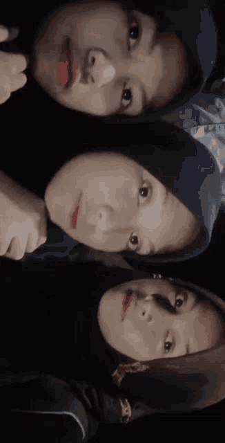 three girls wearing hijabs are posing for a picture together