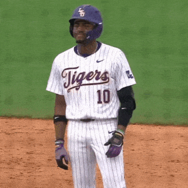a baseball player for the tigers wears a purple helmet
