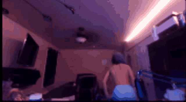 a blurry image of a person standing in a dark room