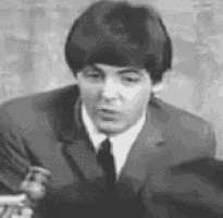a man in a suit and tie is sitting at a table .
