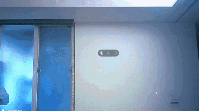 a white wall with a blue door and a circle on it