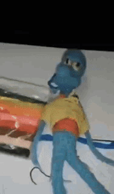 a squidward from spongebob squarepants is holding a hook