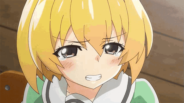 a girl with yellow hair is crying with a white tear coming out of her eye
