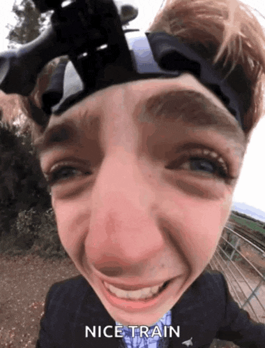 a close up of a person 's face with the words " nice train " below it