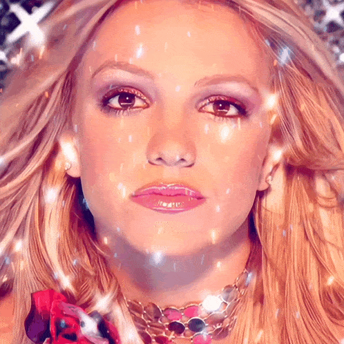 a close up of a woman 's face with a necklace on