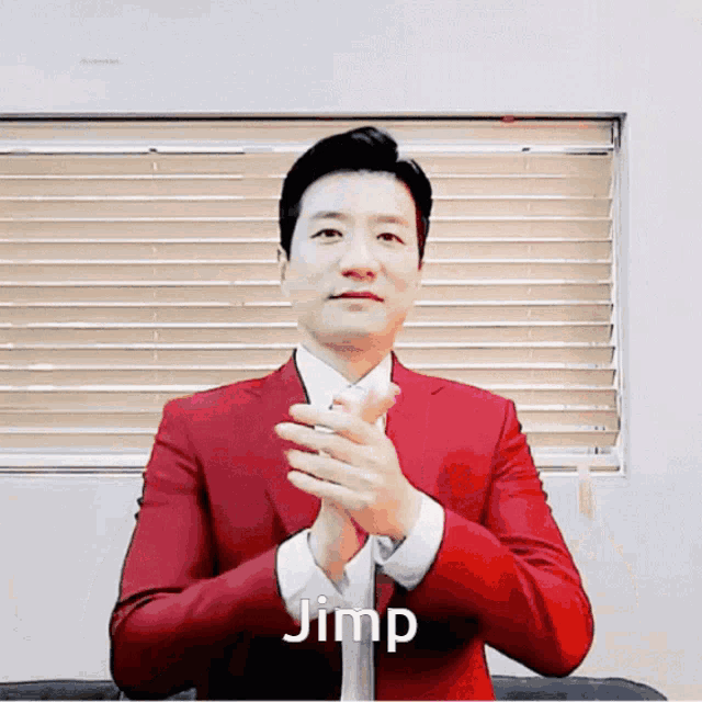 a man in a red suit is clapping his hands and the word jimp is on the bottom