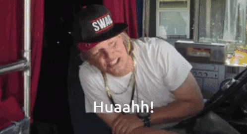 a man wearing a swag hat and a white shirt says huaahh