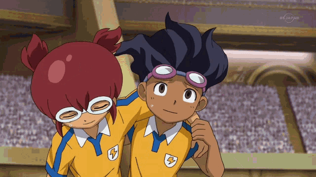 a boy and a girl are standing next to each other and the boy has a lightning bolt on his uniform