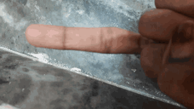 a close up of a person 's finger pointing to the left