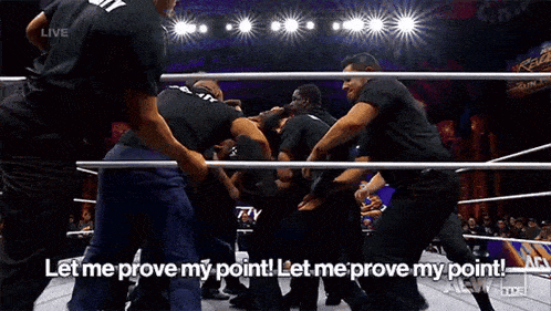 a group of men are fighting in a wrestling ring and one of them is saying let me prove my point
