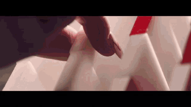 a close up of a person 's finger touching a white object