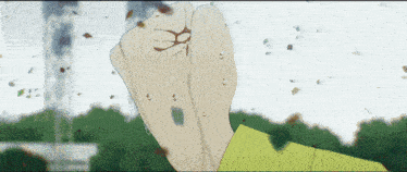 a close up of a person 's fist with leaves flying around