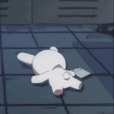 a stuffed animal is laying on the floor in a dark room