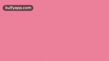 a chocolate bar with white frosting on a pink background