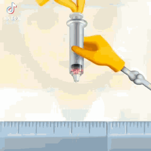 a hand is holding a syringe next to an apple on a counter .