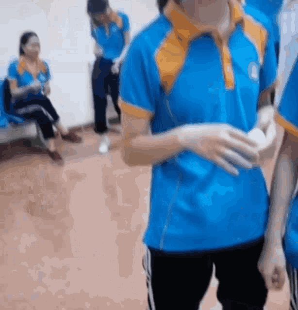 a person wearing a blue and orange shirt with the letter a on it