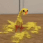 a yellow duck made out of pipe cleaners is sitting on a table .