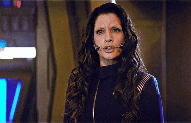 a woman with long hair and a fake eyebrow