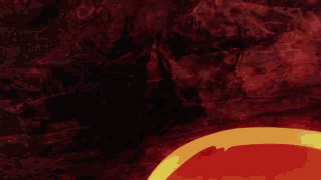 a red and yellow flame is coming out of a rock