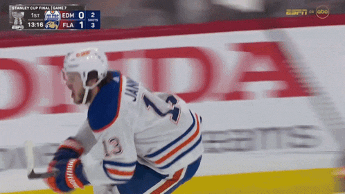 a hockey player with the number 13 on his jersey is on the ice