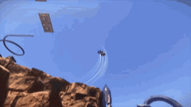 a man is flying through the air with a kite that says ' a ' on it