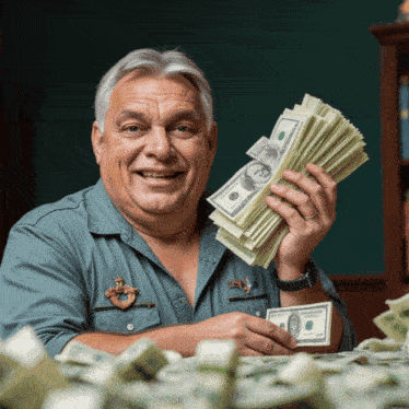 a man holding a stack of 100 dollar bills in his hands
