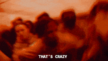 a blurry picture of a group of people with the words that 's crazy above them .