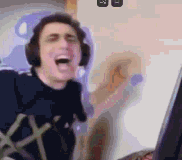 a man wearing headphones and a shirt with the letter x on it