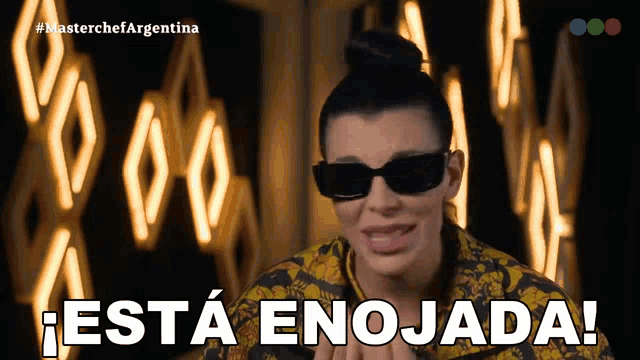 a woman wearing sunglasses says " esta enojada "