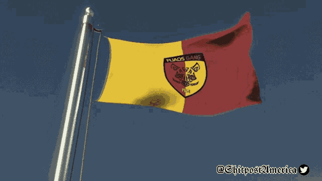 a yellow and red flag is flying in the wind with a twitter logo in the corner