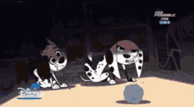 three dalmatian dogs are playing with a ball in a dark room with a disney logo in the corner