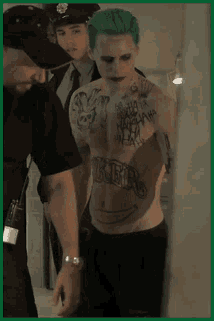 a shirtless man with a tattoo on his chest that says " joker "