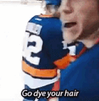 a hockey player is saying `` go dye your hair '' while standing on the ice .