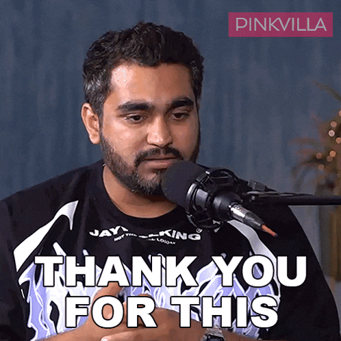 a man sitting in front of a microphone with the words thank you for this below him