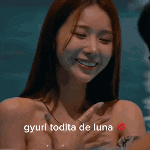 a woman with a tattoo on her arm is smiling with the words gyuri todita de luna below her
