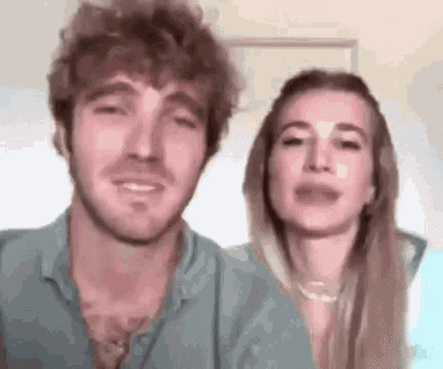 a man and a woman are standing next to each other in a room .
