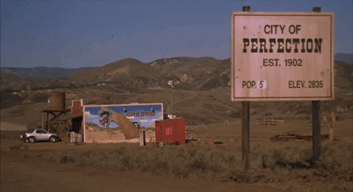 a sign that says city of perfe on it in the desert