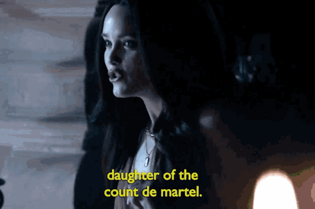 a woman in a dark room with the words daughter of the count de martel