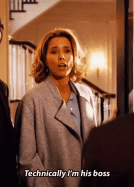 a woman says " technically i 'm his boss " while standing in a doorway