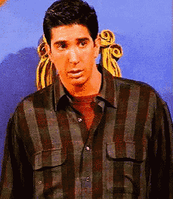 a man in a plaid shirt is standing in front of a blue background