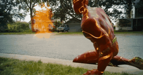 a man in a flash costume is kneeling down