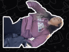 a girl in a purple hoodie is laying on her stomach on a black background .