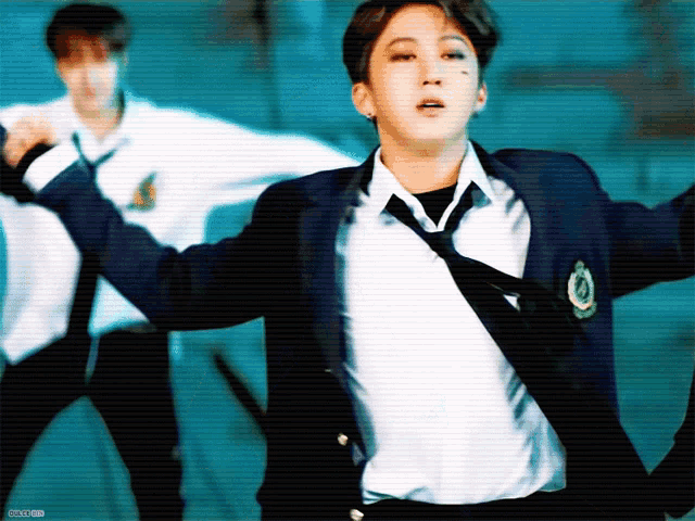 a man in a suit and tie is dancing with another man