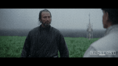 two men are standing in a field with the words rogue one star wars on the bottom