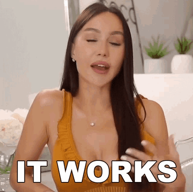 a woman in a yellow tank top is saying " it works "