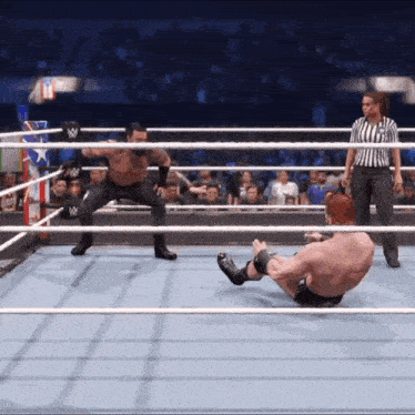 two wrestlers in a wrestling ring with a referee in the background
