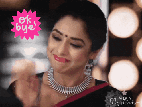 a woman wearing a necklace and earrings is smiling with an ok bye sticker behind her