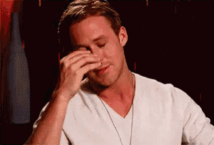 a man in a white shirt is rubbing his nose .