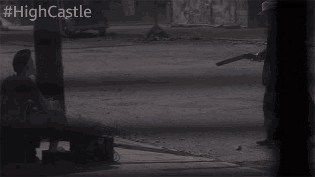 a man holding a gun with the hashtag #highcastle on the bottom