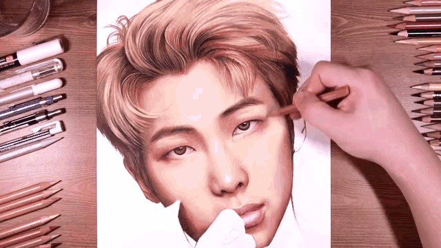 a person is drawing a portrait of a man with a pencil